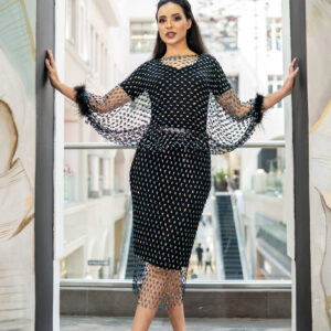 Turn heads in this sophisticated two piece ensemble featuring a sleek black inner dress, paired with a sheer embellished overlay accessory dress.Adorned with delicate turquoise crystal patterns, the dress sparkles with every move. The dramatic sheer balloon sleeves finished with soft feather cuffs add a touch of vintage glamour.  Perfect for evening soirées, cocktail parties, or any occasion where you want to make a statement in timeless elegance.