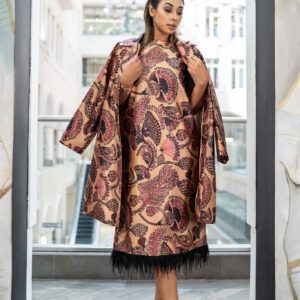 This luxe set features a sleeveless A-line midi dress and a matching longline jacket, both crafted in a rich satin fabric with an intricate botanical print in warm tones of rose, plum, and deep berry. The dress is finished with delicate feather trim at the hem for a touch of playful sophistication, while the coordinating jacket adds structure and refinement. Wear them together for a striking statement look, or style separately for versatile chic.  Color: Nude base with berry-toned floral print Details: A-line midi dress with feather trim | Coordinating patterned jacket Style: Statement | Elegant | Versatile