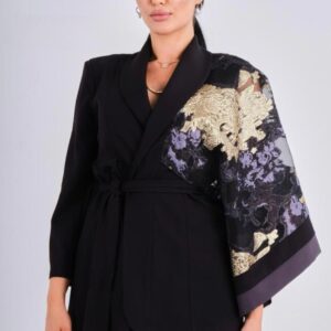 This striking two-piece set pairs sleek black wide-leg pants with a tailored belted jacket that redefines sophistication. The standout detail lies in the jacket’s one-of-a-kind sleeve — crafted in sheer organza with intricate gold and lilac embroidery, adding a couture-inspired flair. The wrap-style belt cinches the waist for a flattering silhouette, while the structured tailoring balances drama with elegance. Perfect for evening occasions, formal events, or high-fashion moments where you want to stand out.  Color: Classic Black with gold & lilac embroidered detail Details: Tailored belted jacket with statement sleeve | Wide-leg trousers Style: Artistic | Elegant | Statement