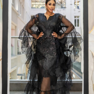Midnight Mirage Crushed Brocade Kaftan A vision of effortless sophistication, this black kaftan is crafted from luxurious crushed brocade and layered with soft sheer organza for a beautifully fluid finish. The silhouette is loose and free-flowing, offering graceful movement and comfort, yet can be cinched with a belt for a more defined shape and evening elegance. Includes inner.  Billowing organza sleeves and cascading ruffles add a touch of romantic drama, while the textured brocade subtly shimmers under light, exuding refined allure. Perfect for special occasions, Eid celebrations, or elegant soirées.This piece captures the essence of modern modest luxury.