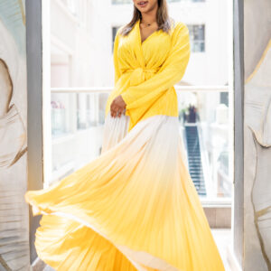 Pleated Ombre Ensemble A statement in sunshine hues, the Golden Dawn ensemble embodies effortless sophistication and optimism. Crafted from lightweight pleated fabric, the design features a wrap-style top with soft draping and a self-tie belt, paired with a flowing ombré skirt that fades beautifully from vibrant yellow to ivory. The interplay of texture and color creates movement and luminosity, making it ideal for daytime occasions, garden soirées, or resort-inspired elegance. A timeless silhouette that flatters every shape while radiating warmth and joy.