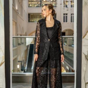 Black Lace Suit Set  Sophisticated, modern, and effortlessly striking, this black lace suit set brings a fresh couture edge to classic tailoring. Crafted from premium embroidered lace, the set features a structured blazer with a single gold button closure, paired with wide-leg lace trousers that offer fluid movement and a refined semi-sheer finish. A tailored inner short ensures confident, comfortable wear while maintaining the elegance of the silhouette.  Perfect for upscale dinners, evening events, and statement occasions where polished glamour is essential.