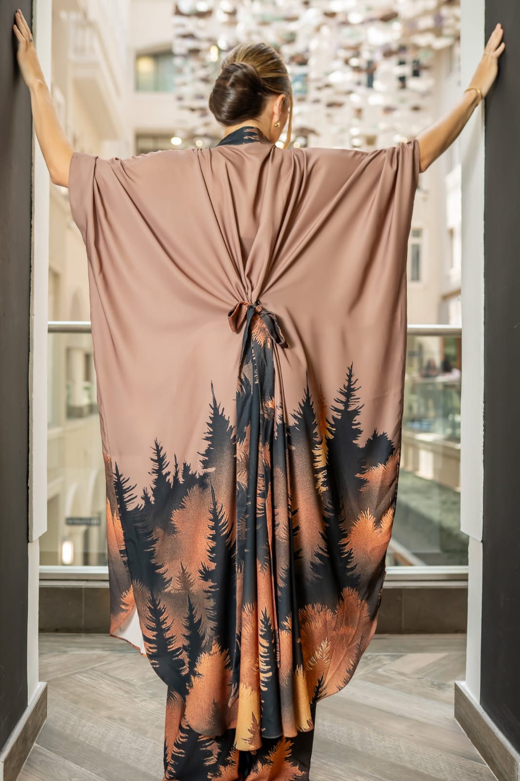 Desert Nocturne This two-piece ensemble features a structured button-down tunic with a softly sculpted mandarin collar and gold-tone statement buttons, flowing into a dramatic cape silhouette sleeve. The back reveals an exquisite gathered drape detail with a tie accent, creating movement and architectural depth from every angle - Image 3