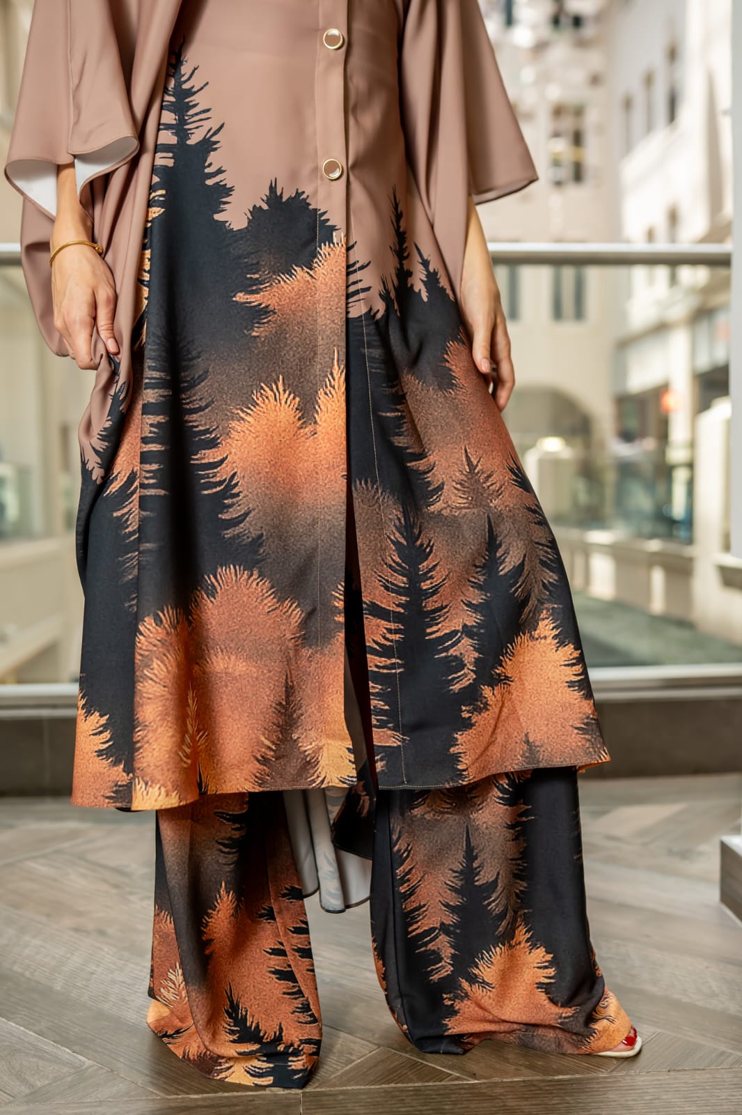 Desert Nocturne This two-piece ensemble features a structured button-down tunic with a softly sculpted mandarin collar and gold-tone statement buttons, flowing into a dramatic cape silhouette sleeve. The back reveals an exquisite gathered drape detail with a tie accent, creating movement and architectural depth from every angle - Image 5